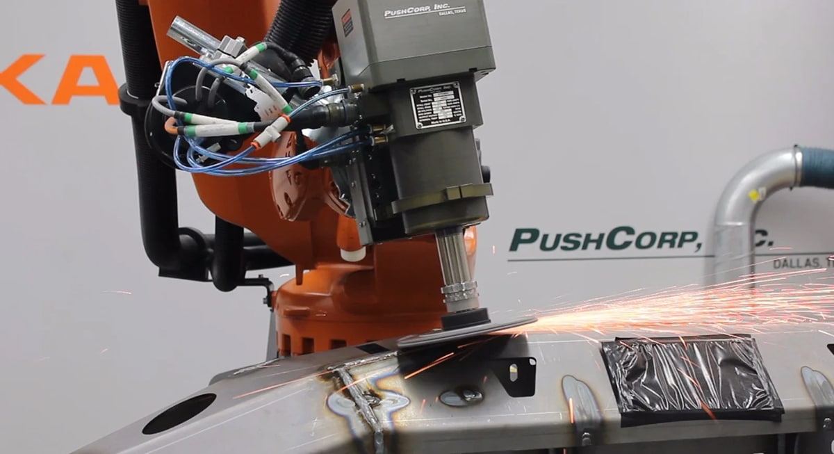 PushCorp's end-of-arm robotic grinding tool working on a car bumper.